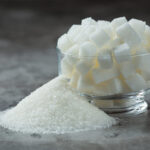 World diabetes day;
Sugar cubes in a glass bowl on dark floor